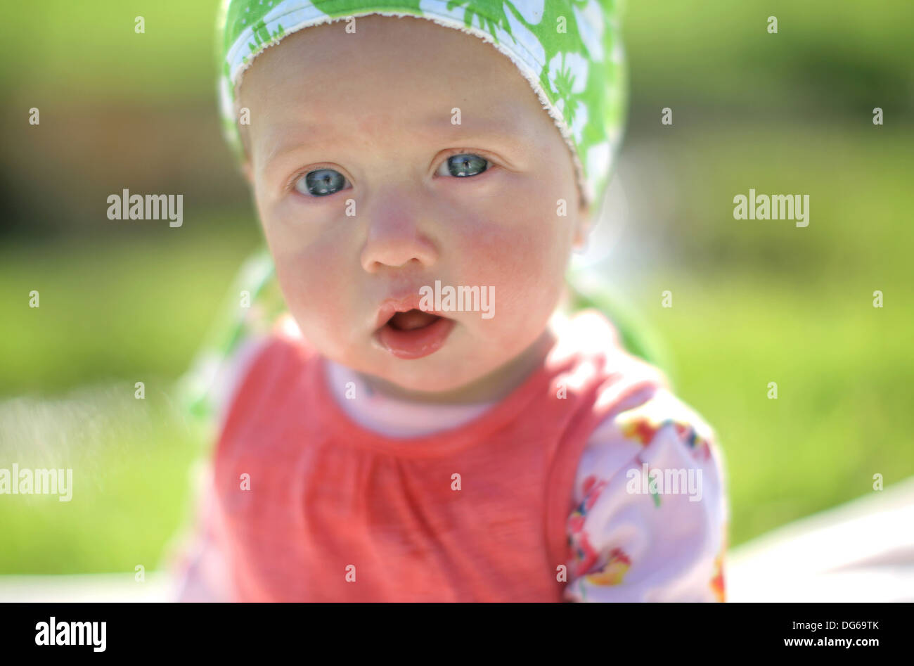 baby in sun hat enjoying the British summer Stock Photo