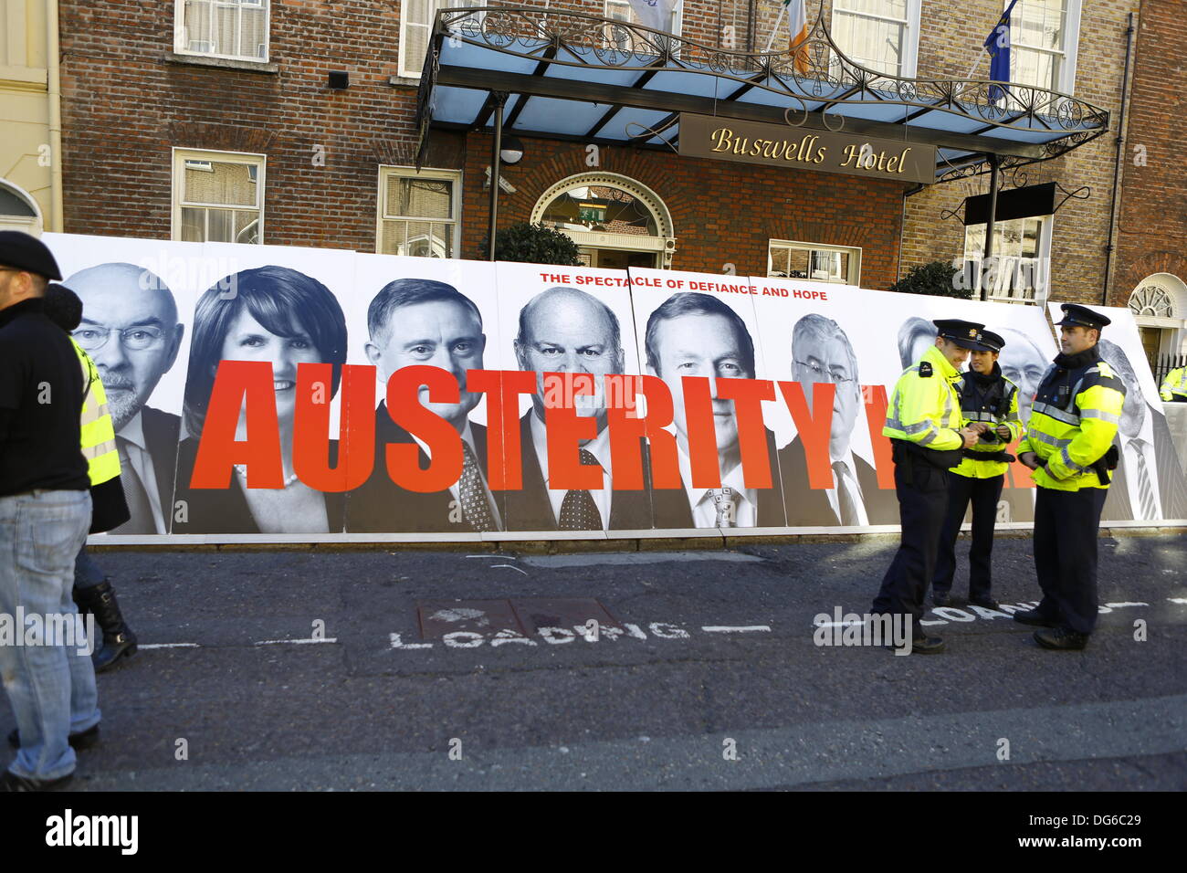 Dublin, Ireland. 15th October 2013 The Spectacle of Defiance & Hope have put up large pictures of government ministers with the slogan 'Austerity kills' written over them. People have assembled from early morning outside the Dail (Irish Parliament) on the day Finance minister Michael Noonan is going to present the Budget for 2014. They protest against the increase in taxes and the cuts in government spending. Credit:  Michael Debets/Alamy Live News Stock Photo