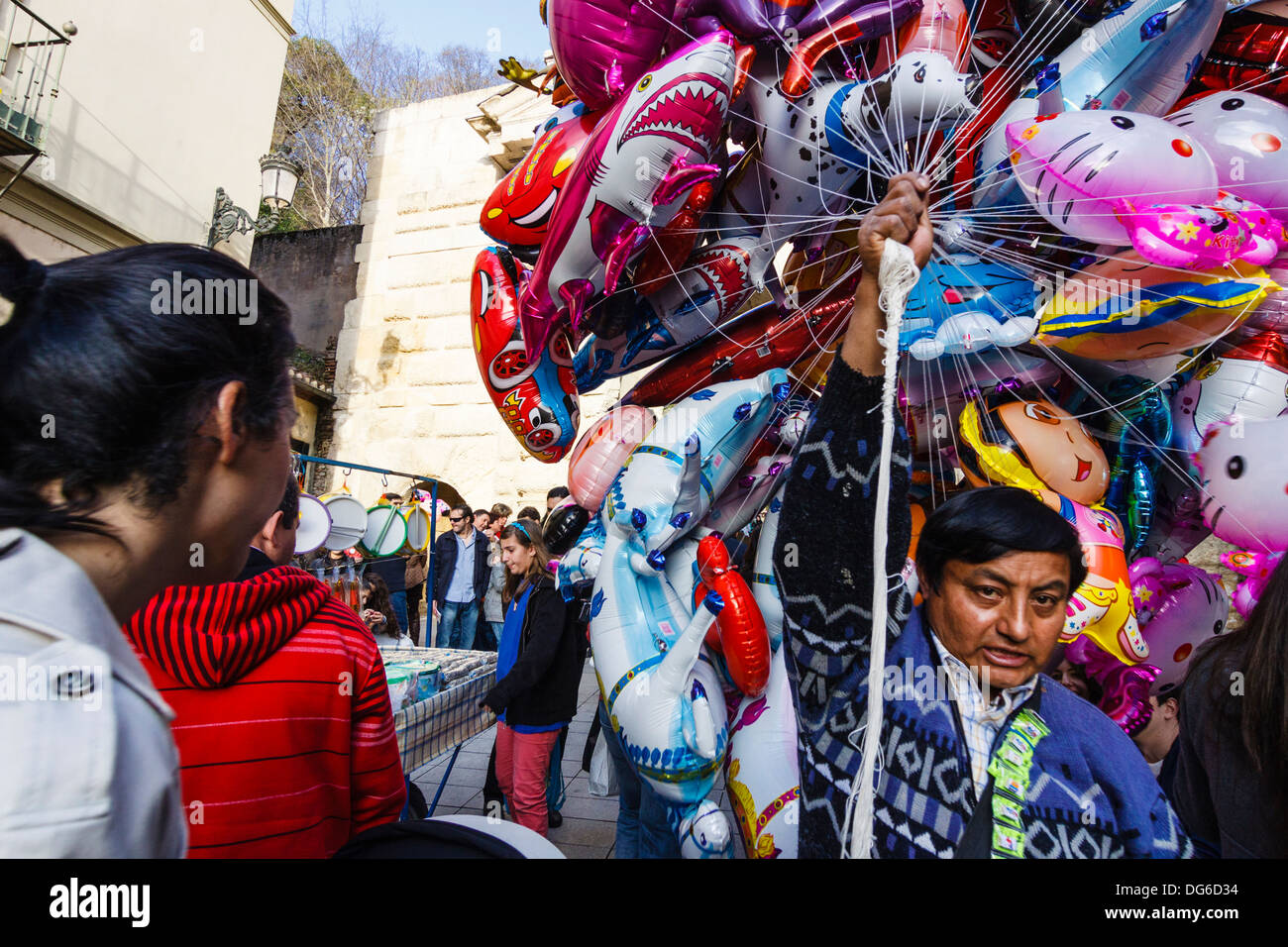 South American immigrant selling balloons in Granada, Spain Stock Photo