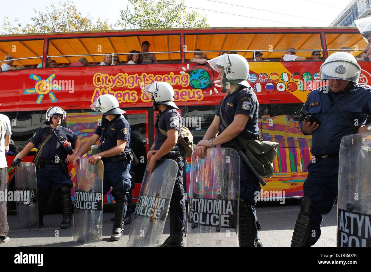 Athens, Greece. 15th Oct, 2013. Tourists atop a sightseeing bus watch a ...