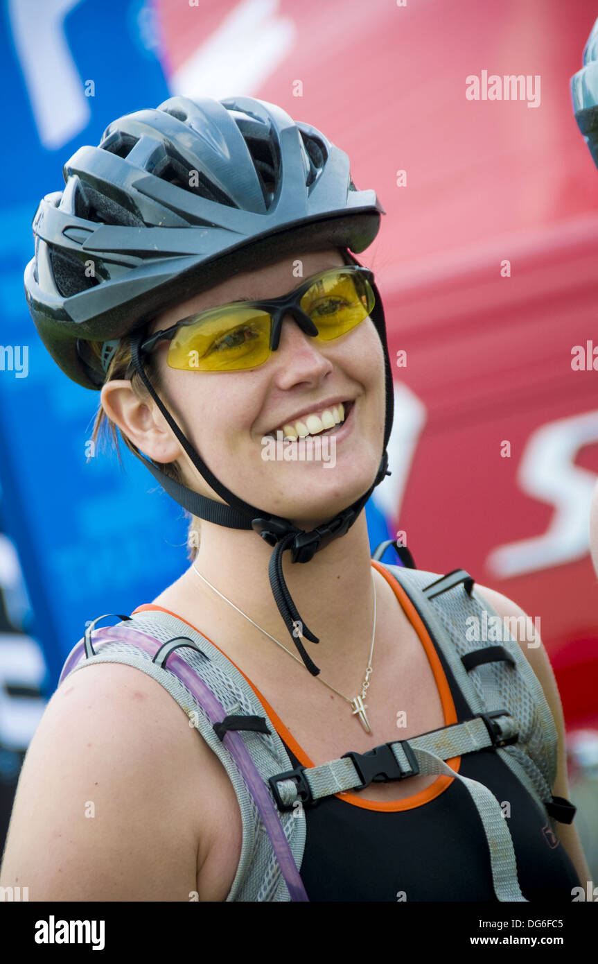 Young woman cyclist wearing safety helmet at Mountain bike Stock Photo