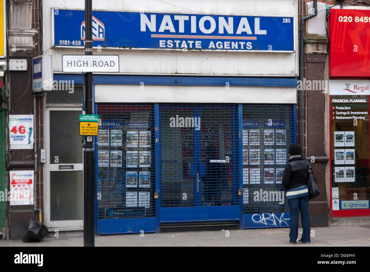 London, UK. 15th October 2013. Unlike other estate agents in Willeden High Street, National Estate Agents appeared to have shut for the day ahead of protests against lettings agents found to have denied rental properties to Afro-Caribbean homeseekers. Credit:  Paul Davey/Alamy Live News Stock Photo