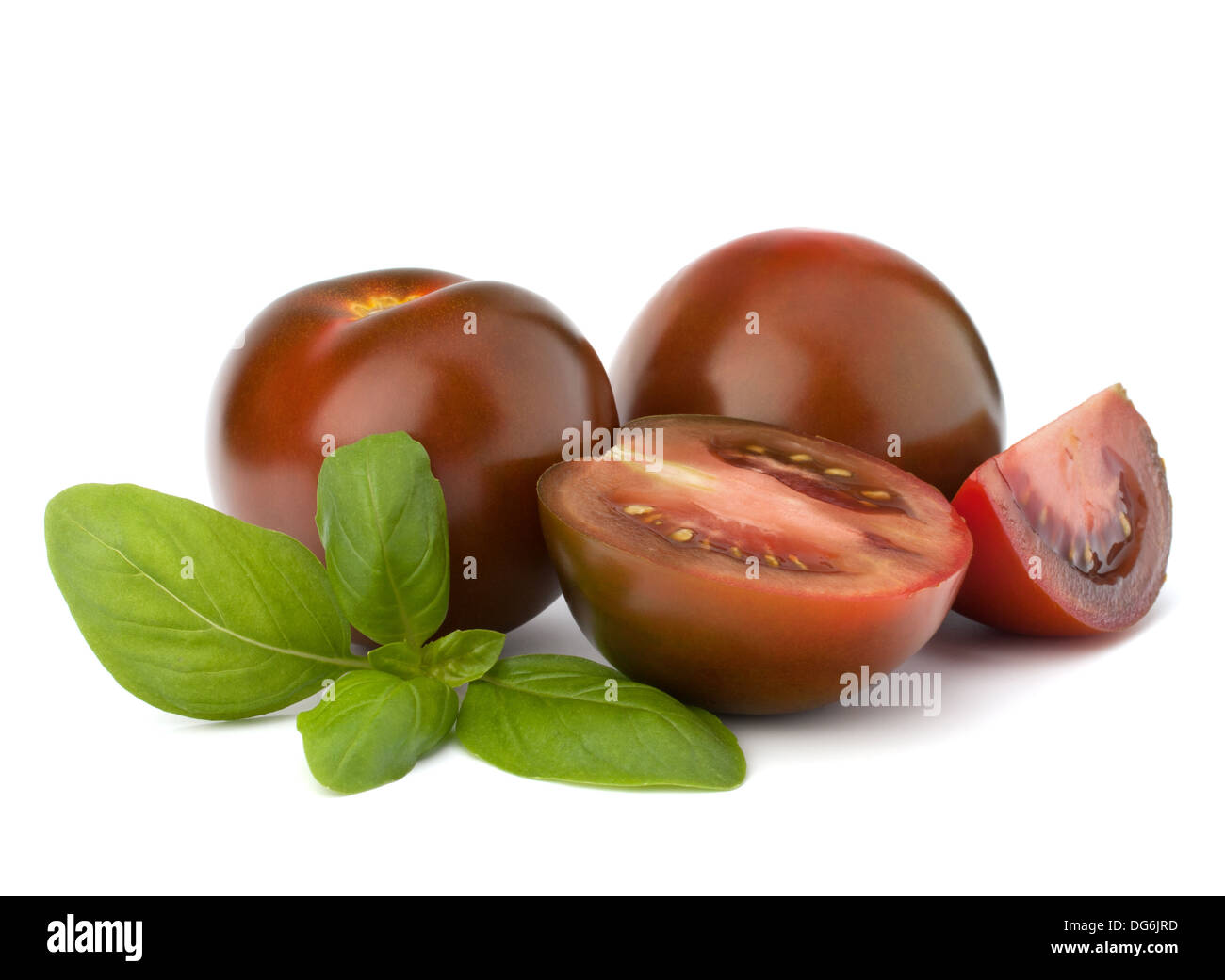 Tomato kumato and basil leaf isolated on white background Stock Photo
