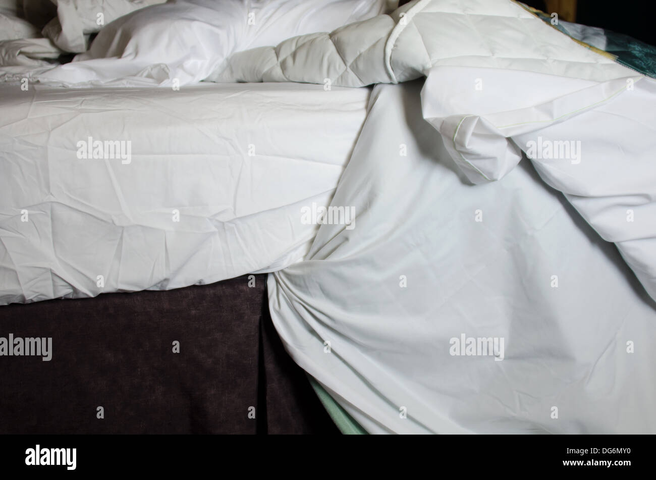 Morning light on rumpled sheets. Stock Photo