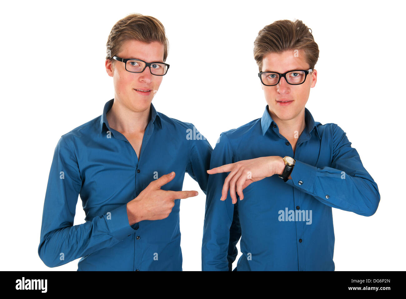 Identically adult male twins pointing to each other in studio Stock ...