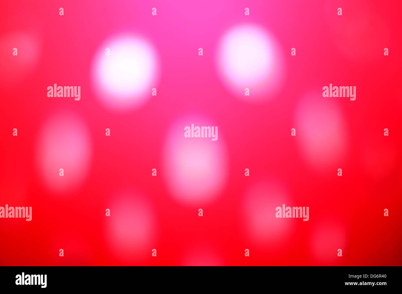 blurred white light spots through red colander Stock Photo