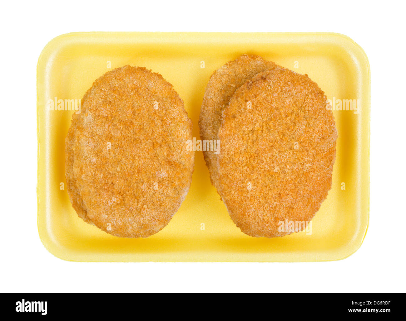 Top view of several pre-cooked frozen veal patties on a yellow butchers tray. Stock Photo