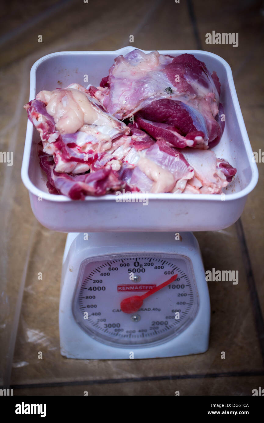Serpong-Banten, Indonesia. 15th October 2013. Cow meat weighted before poured into plastic bag. Muslims in Indonesia celebrate Iedul Adha by slaughtering cows or sheep to give to the poor.  Credit:  Donal Husni/Alamy Live News Stock Photo