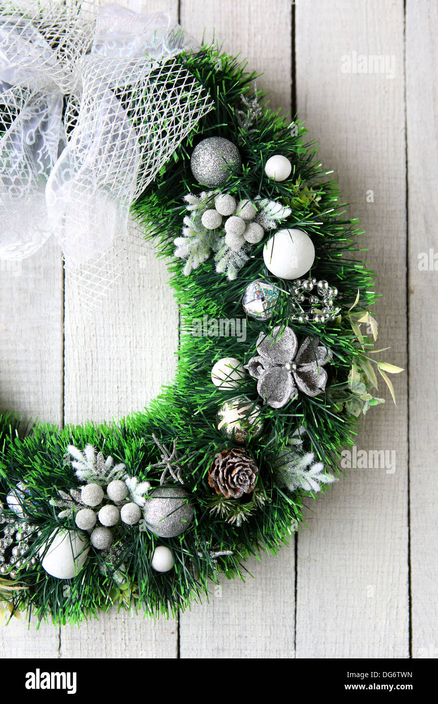 Christmas wreath in silver on white door, food close up Stock Photo