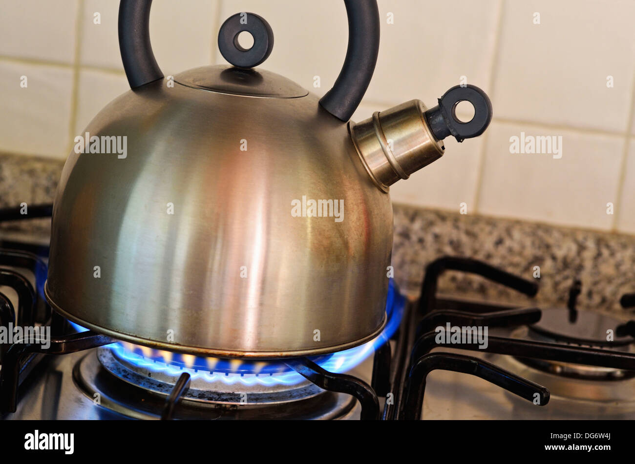 Bronze kettle in modern kitchen. Old vintage teapot on gas stove. Preparing  tea Stock Photo by StudioVK