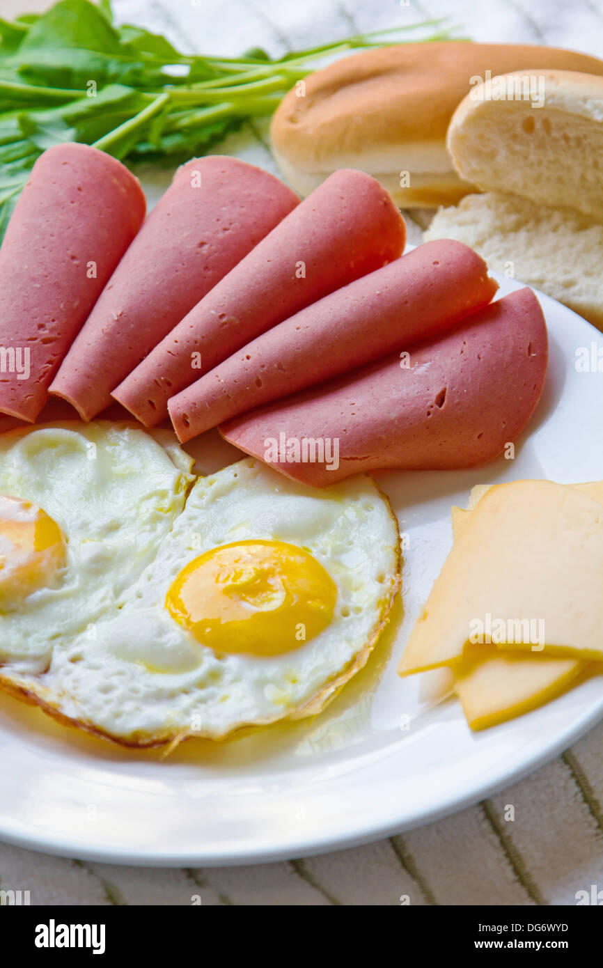 Breakfast plate with Mortadella, eggs, cheese, toasted bun Stock Photo