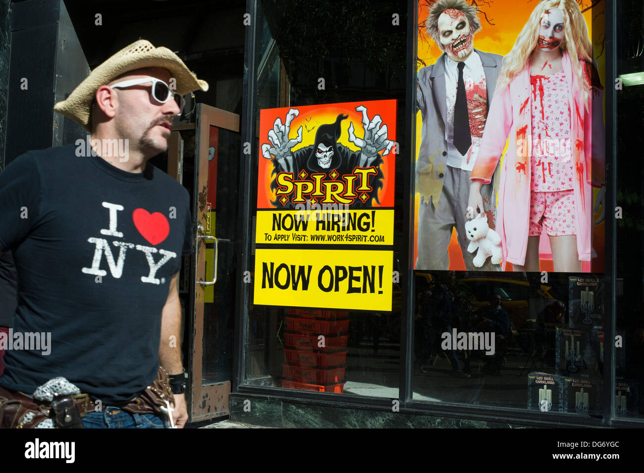 A Now Hiring sign seen in the window of a Spirit Halloween popup store