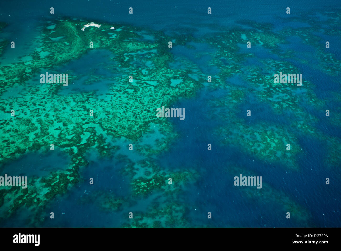 aerial view of colorful coral reef, Upolu Caye,  and  water at Arlington Reef  in Great Barrier Reef Marine Park Stock Photo