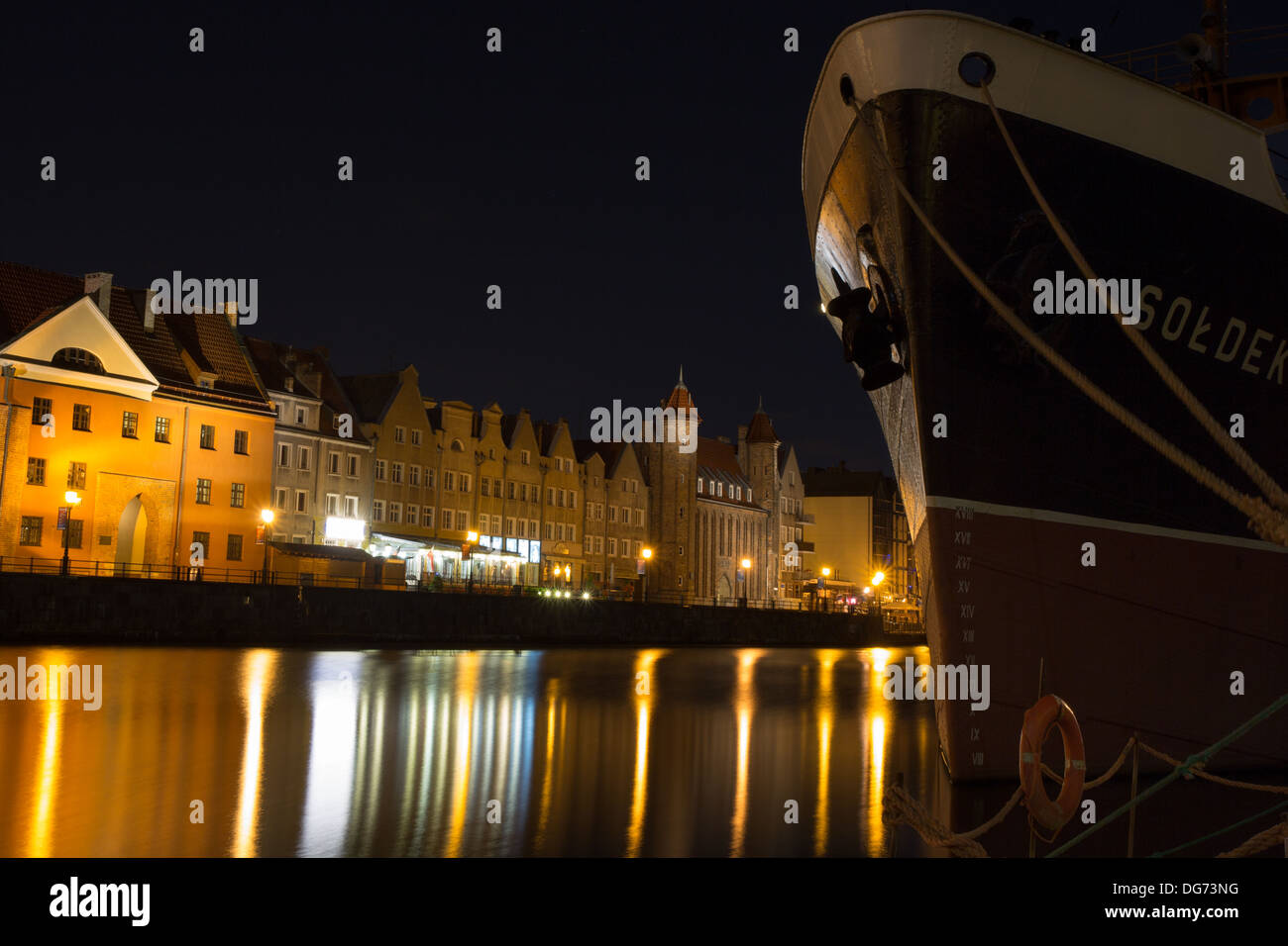 Gdansk Old Town at night by the Motlawa river with the Soldek famous ship, Poland 2013. Stock Photo