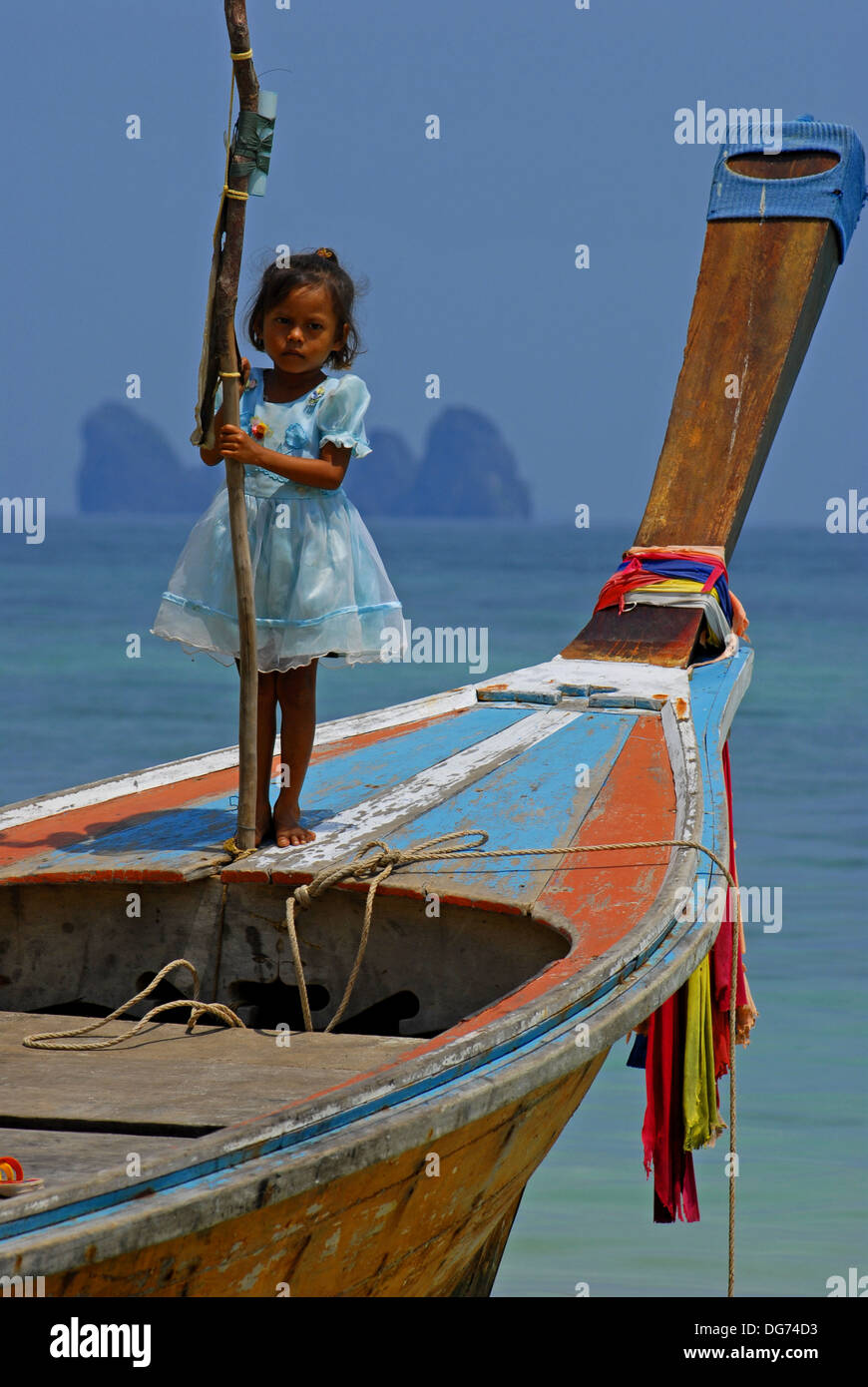 The Sea Gypsies of Thailand - Young sea gypsy girl standing on a longtailed boat (Koh Bulon, Thailand) Stock Photo