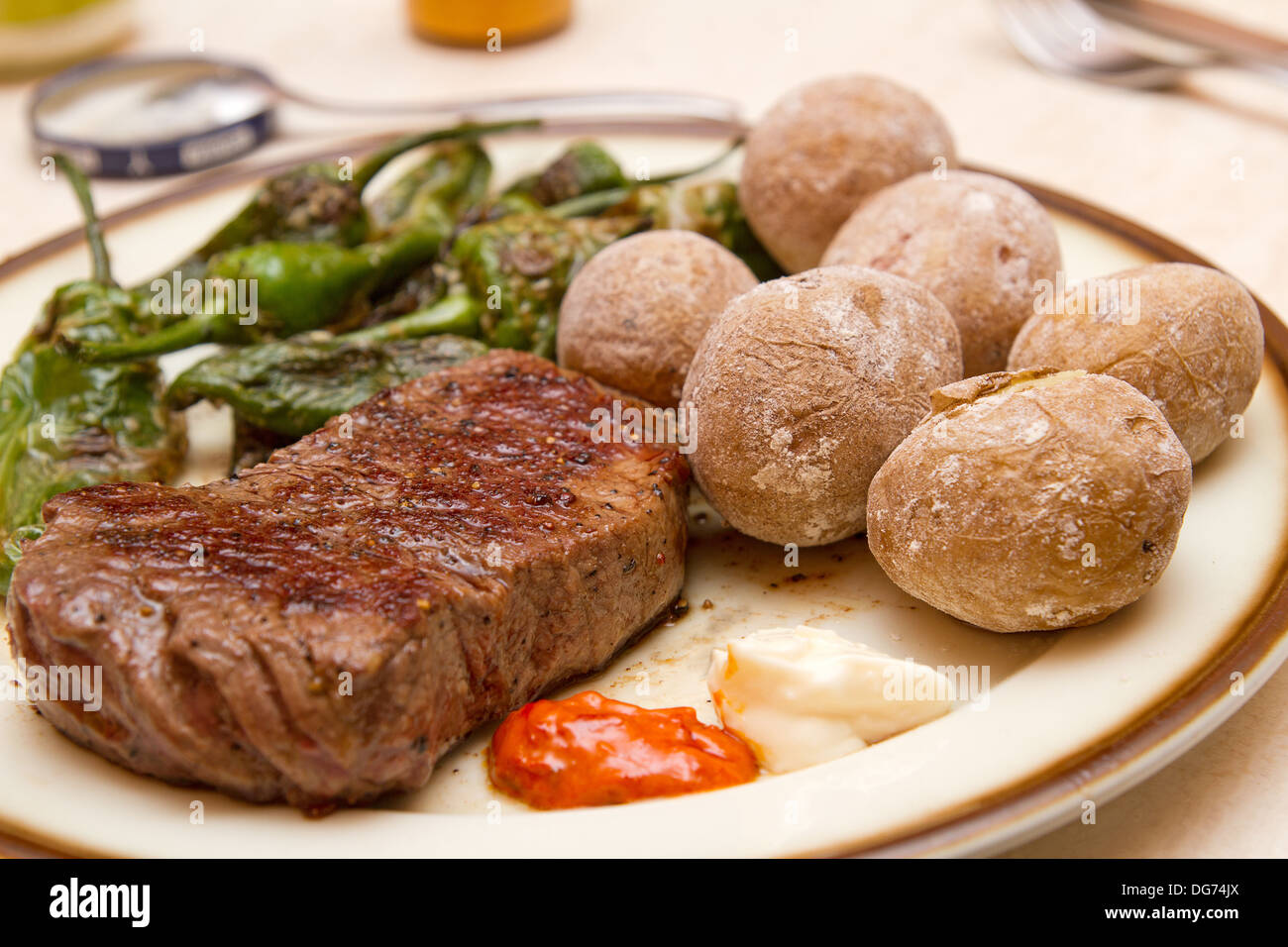 Steak with Papas Arrugadas and Pimientos de Padron Stock Photo