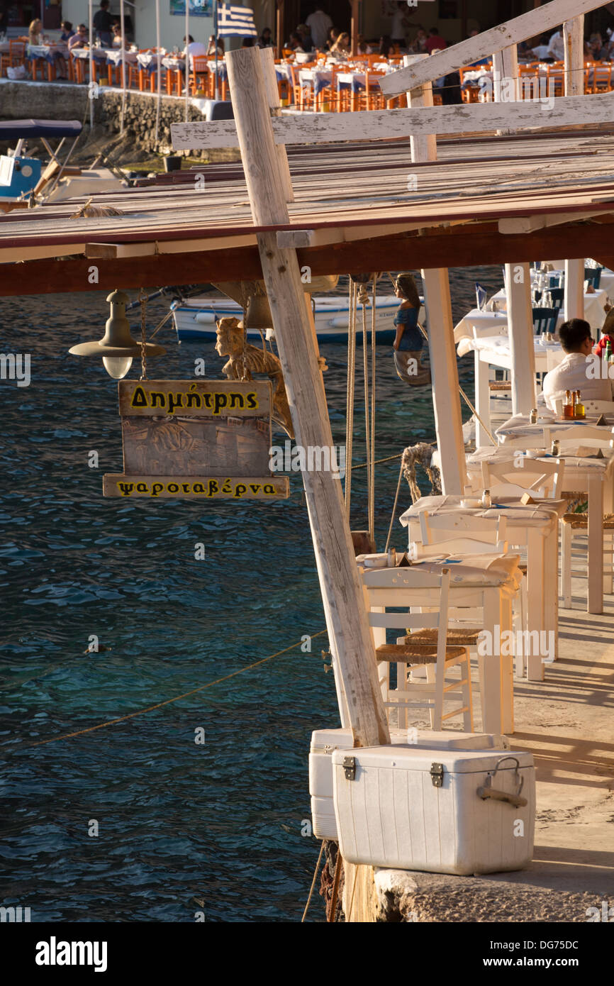 Dressed dinner tables during the sunset at the harbor of Santorini, Greece 2013. Stock Photo