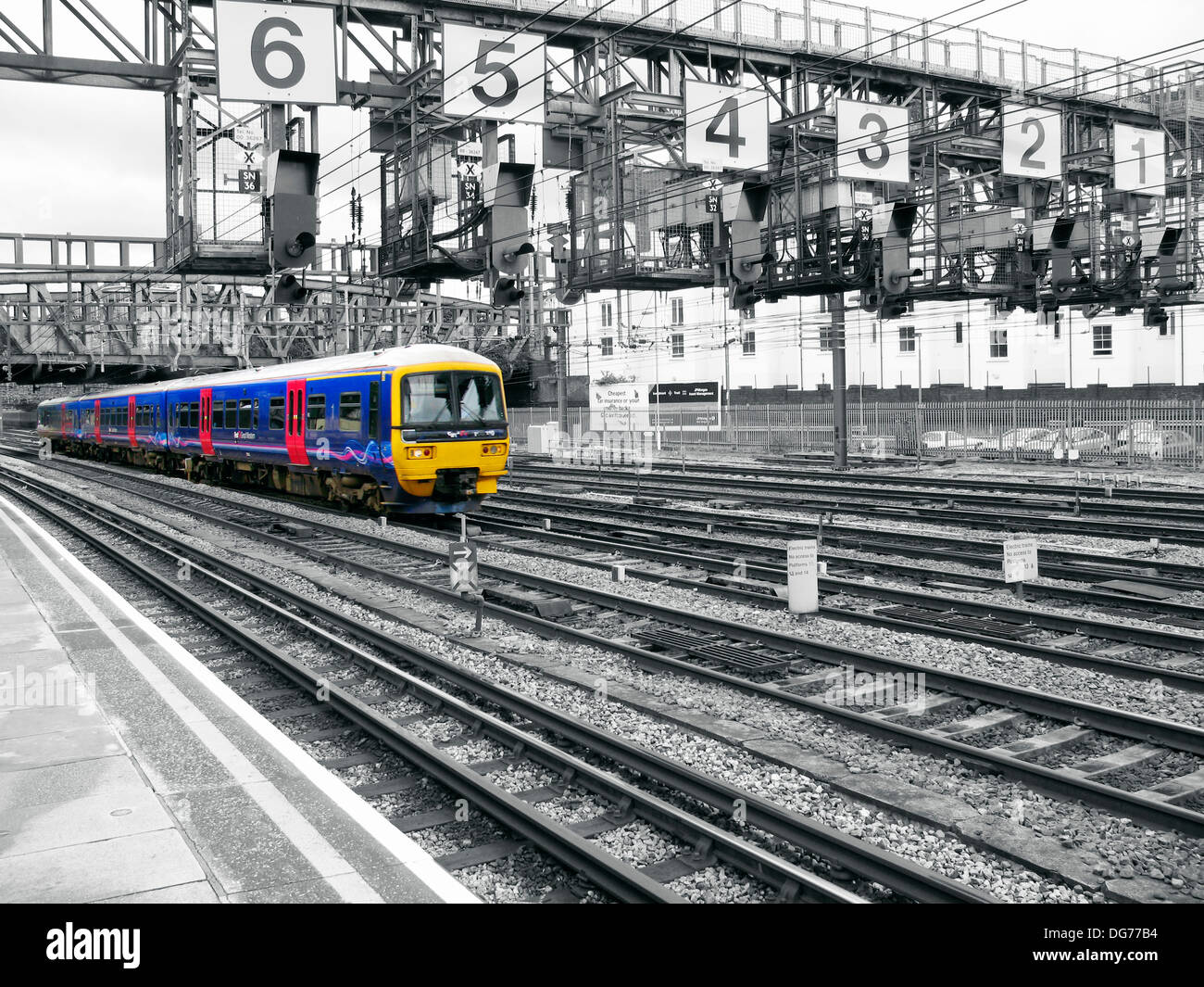 Train arriving to a station in London, England, UK. Photograph in black ...