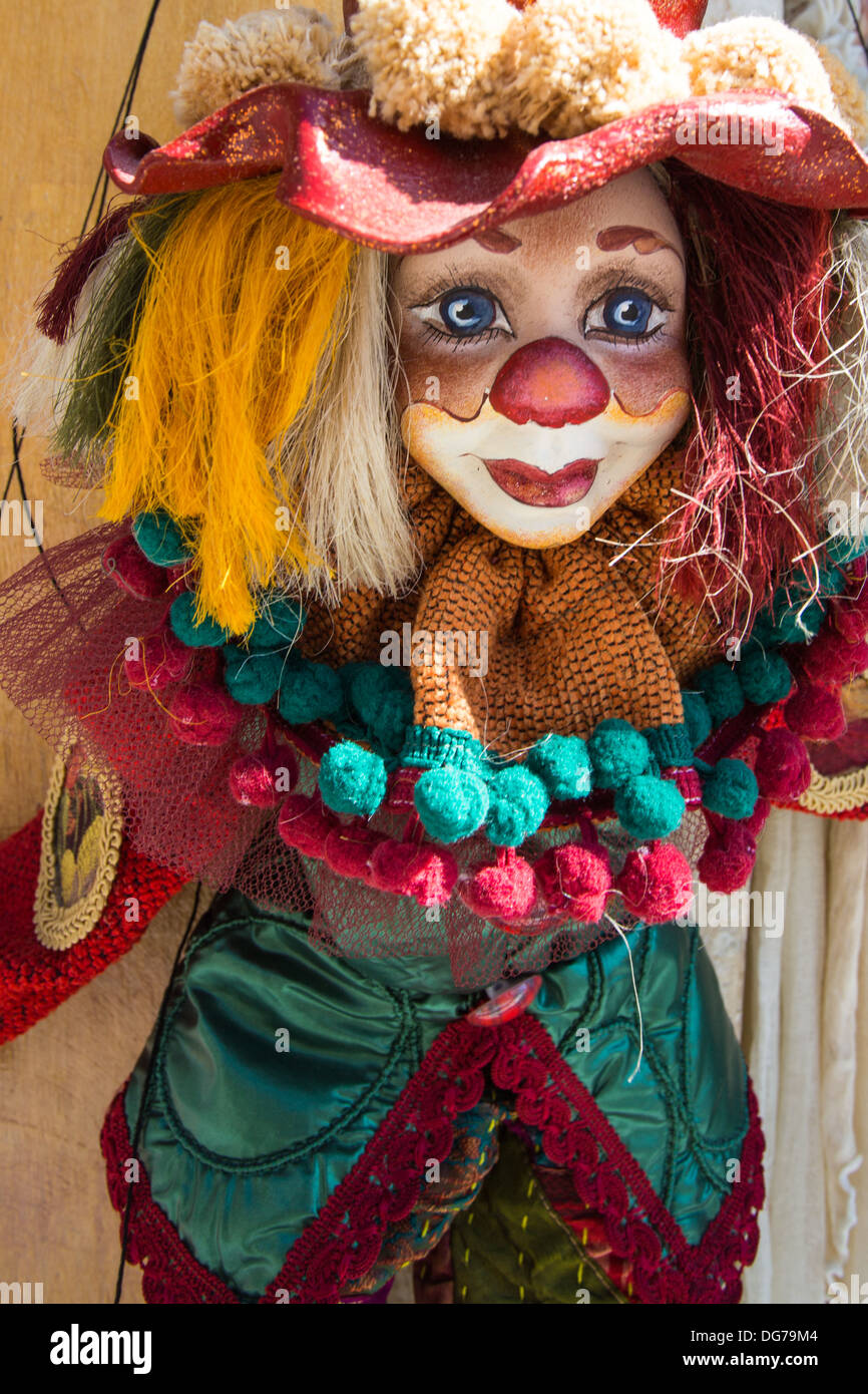 Puppet on a string, colorful clown dressed with clothes in the streets of Santorini, Greece 2013. Stock Photo