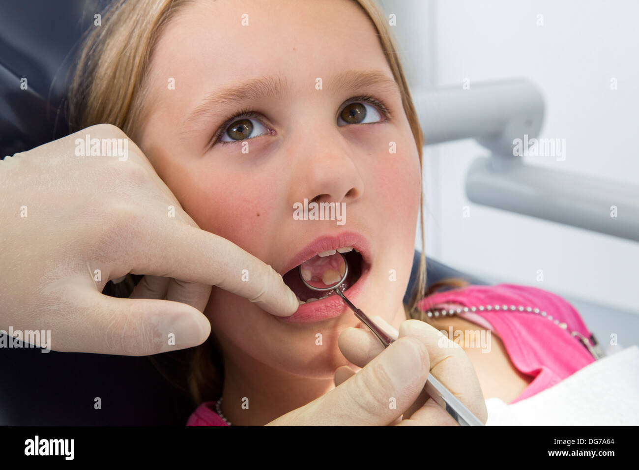 Dental practice, dentistry. Young girl at a dentist treatment Stock