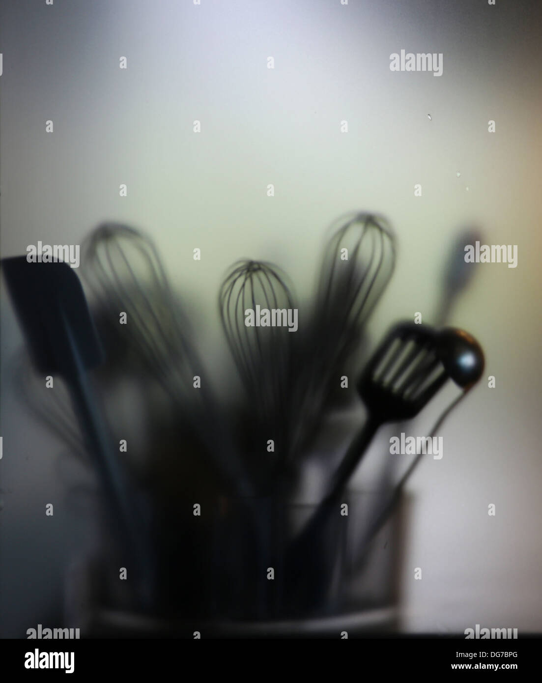 Kitchen tools. blade, brush, skimmer, trough blurry glass Stock Photo