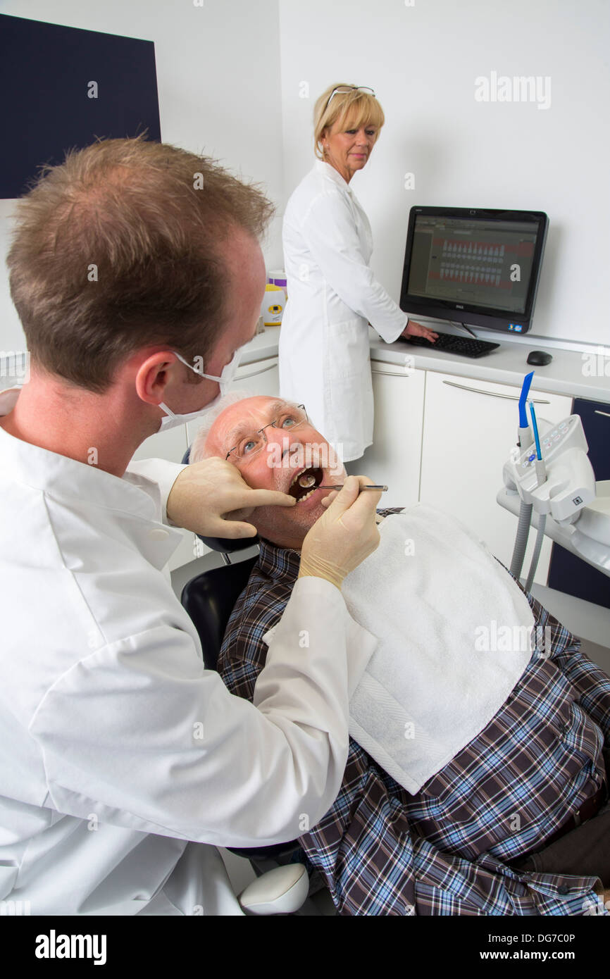 Dental practice, dentistry. Older man at a dentist treatment. Stock Photo
