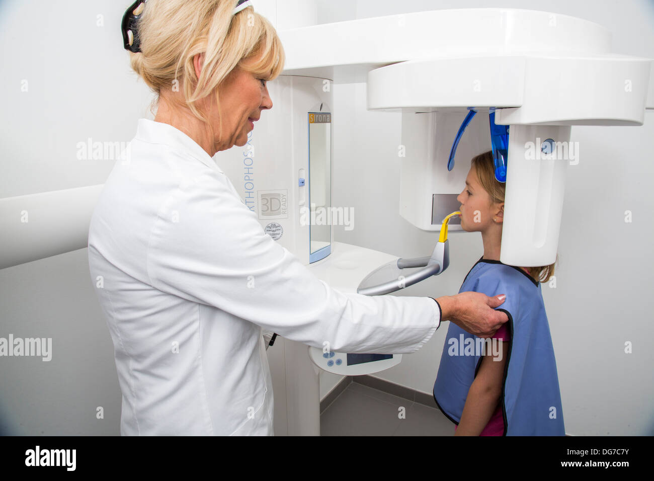 Dental practice, dentistry.Patient prepared for the X-ray of the teeth. Lead vest as radiation protection. Stock Photo