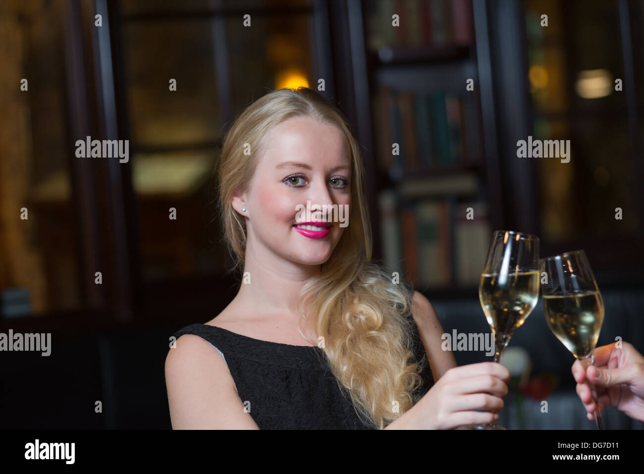 two beautiful women friends spending their evening in an elegant nightclub Stock Photo