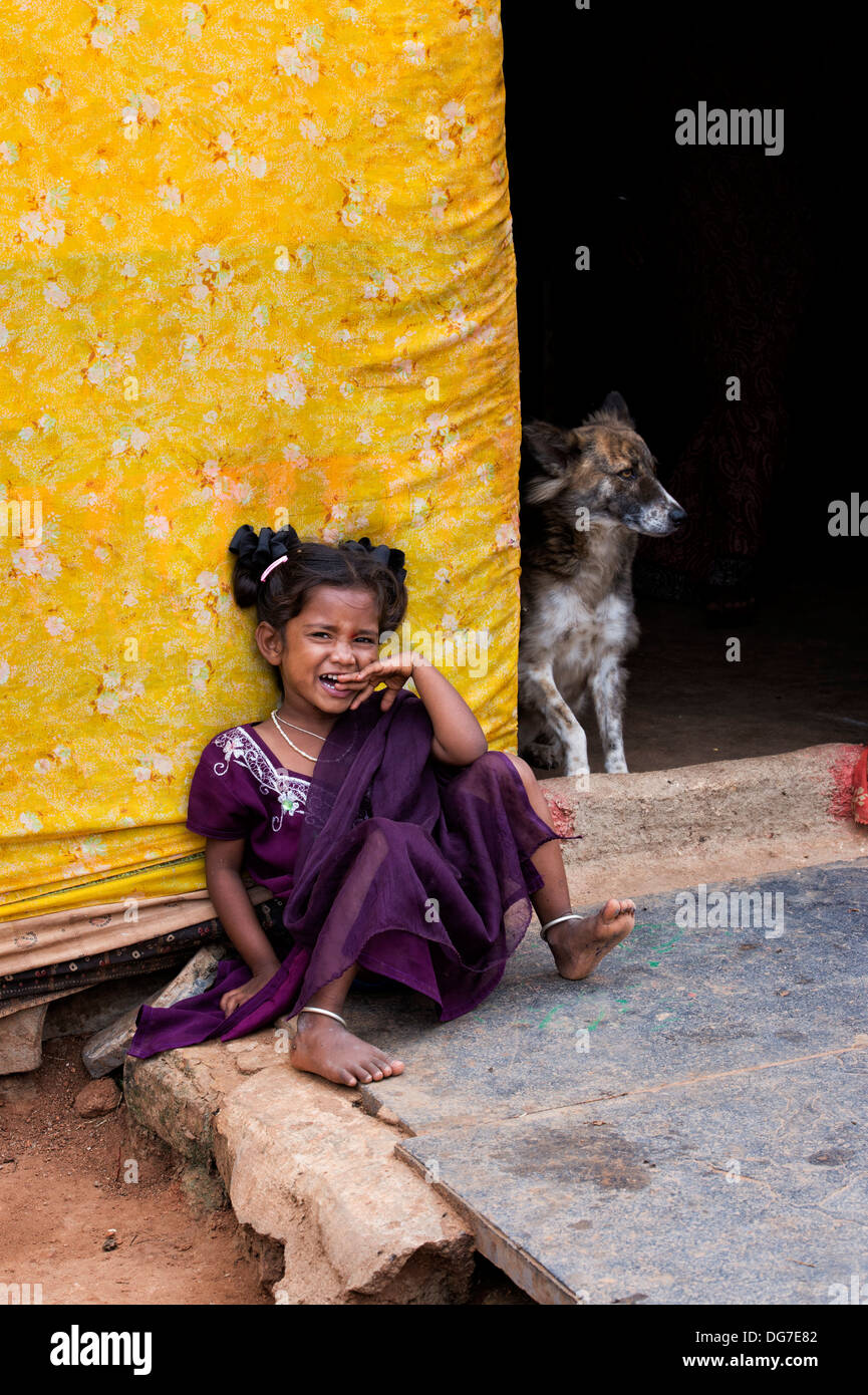 Indian lower caste girl outside her bender / tent / shelter with a dog.  Andhra Pradesh, India Stock Photo