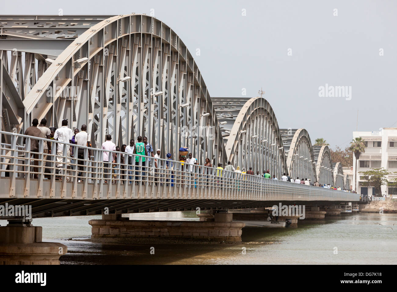 Senegal, Saint Louis. Pedestrians on the Pont Faidherbe, Bridge over the River Senegal. Built 1897. Stock Photo
