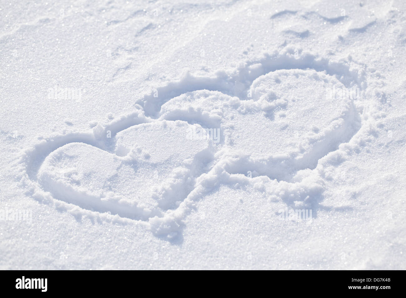 The shape of heart on the snow. Closeup shot. Stock Photo