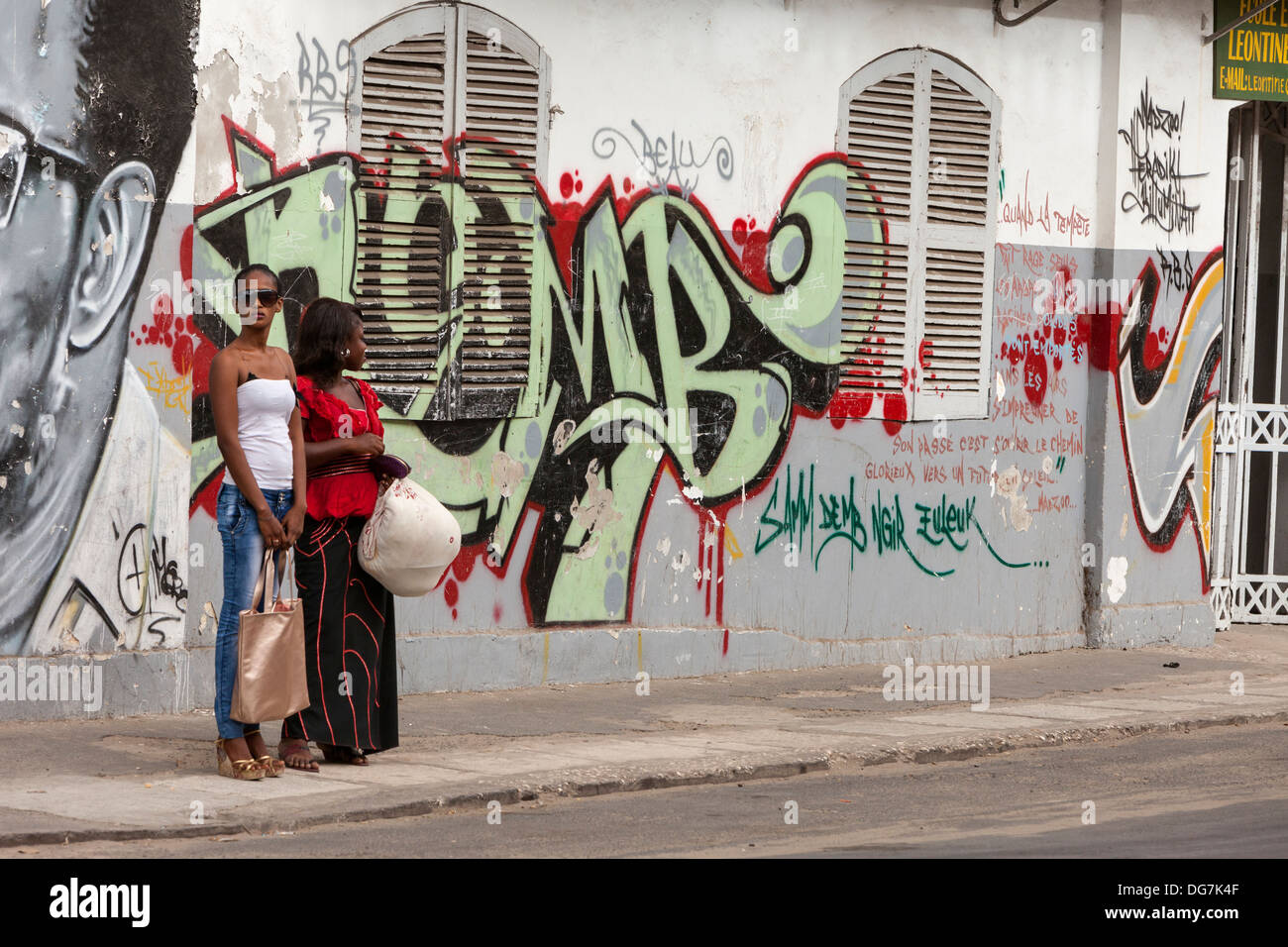 Senegal, Saint Louis. Two Stylish Senegalese Women Waiting for Local Transport. Stock Photo