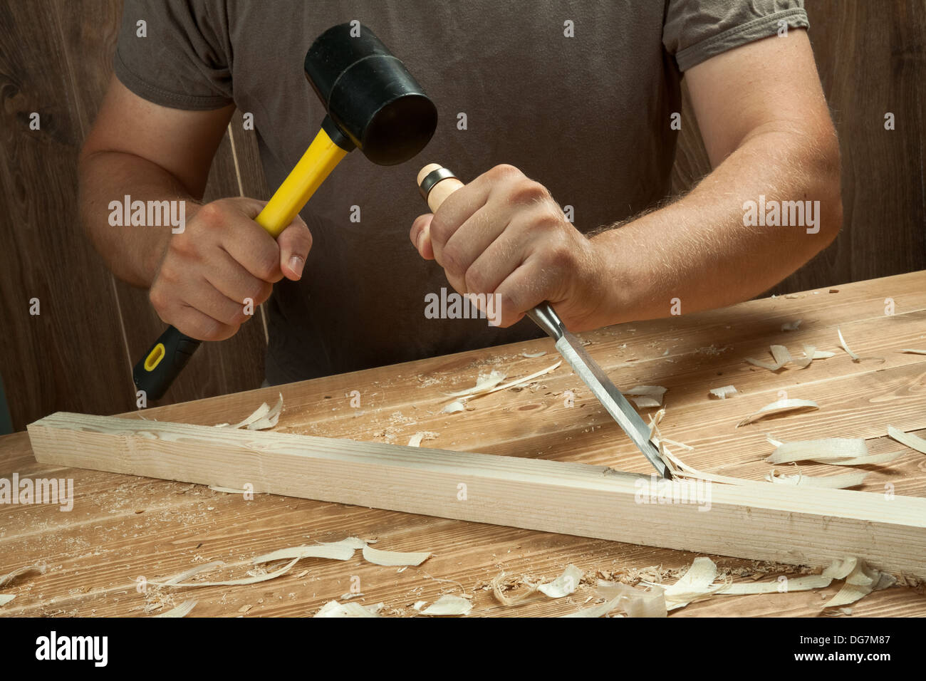 Wood workshop. Carpenter working with chisel. Stock Photo