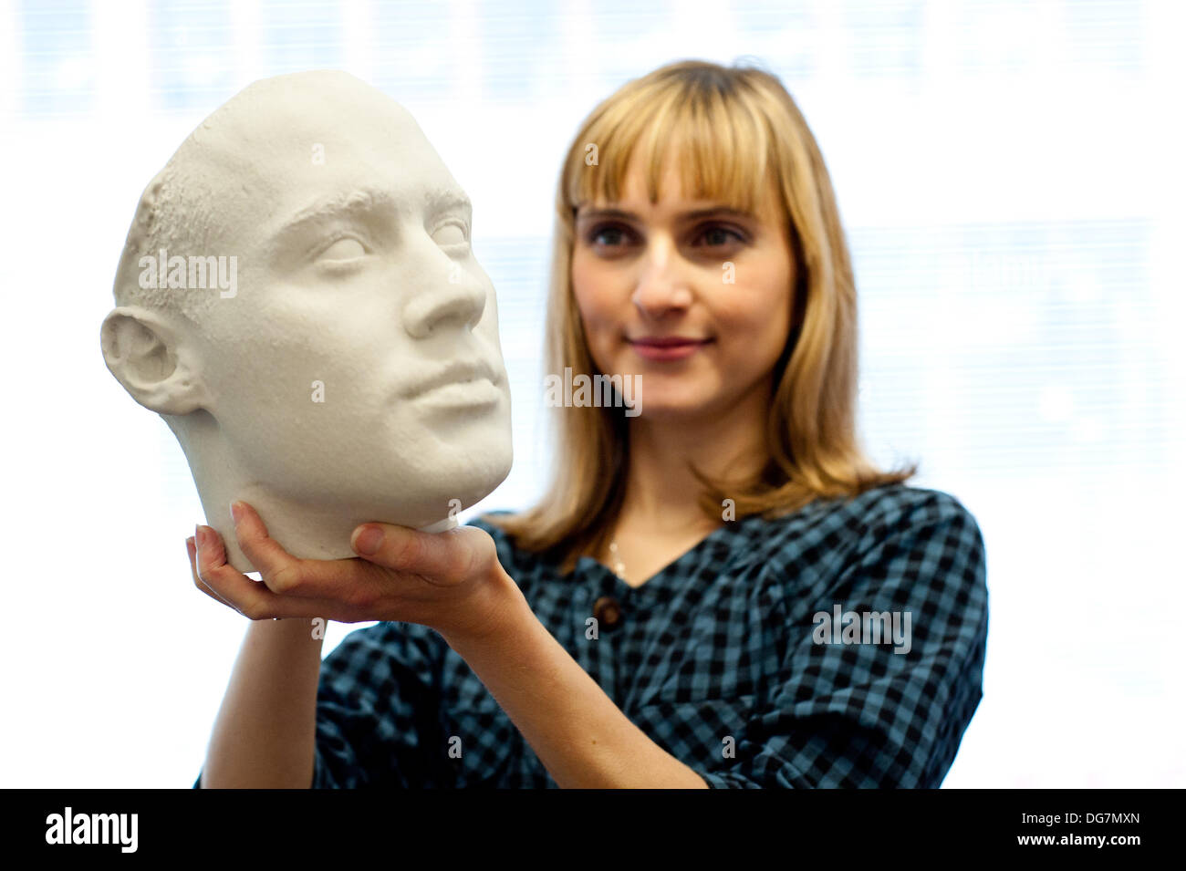 London, UK – 10 October 2013: Kathy Boyce holds a 3D printed head at the Inition demo studio in Shoreditch, East London. Stock Photo