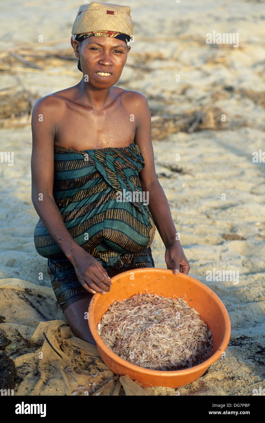 woman catching alevins Sicyopterus lagocephalus with a fishing net, Mananjara on the East coast, Republic of Madagascar, Indian Stock Photo