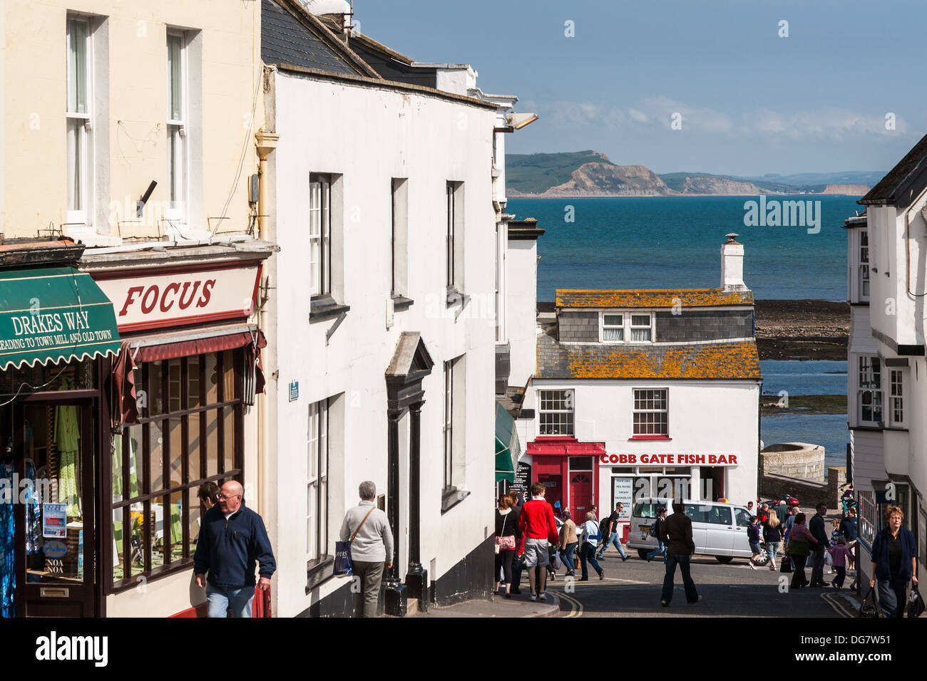 Lyme Regis high street showing shops and fish and chip shop, Dorset