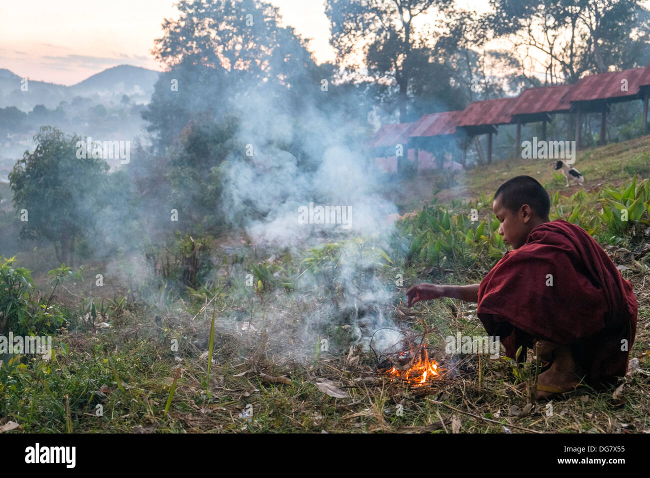 Novice warming at fire, Kalaw, Myanmar, Asia Stock Photo