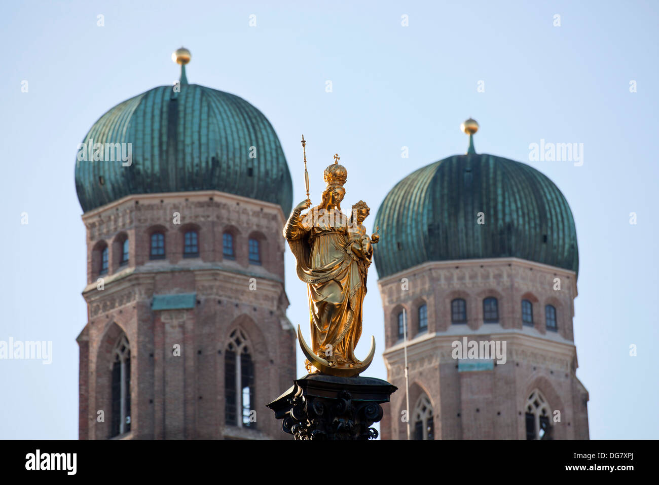 Virgin Mary atop the Mariensäule and the church towers of the Frauenkirche in Munich, Bavaria, Germany Stock Photo