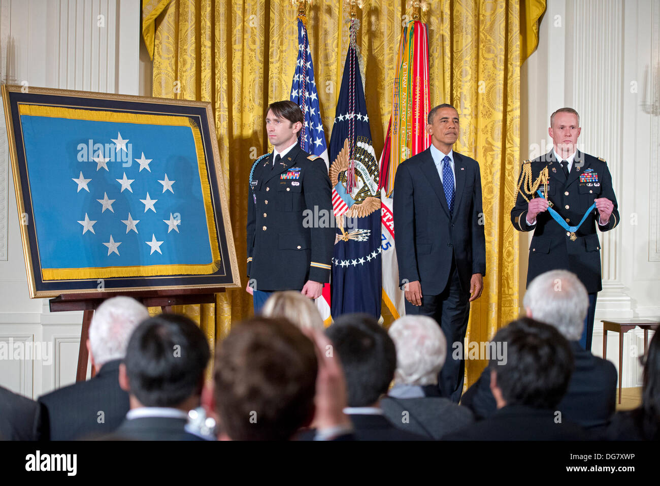 United States President Barack Obama and William Swenson, a former active duty Army Captain, listens as the citation is read prior to Swenson accepting the Medal of Honor for conspicuous gallantry in the East Room of the White House in Washington, DC on October 14, 2013. Captain Swenson accepted the Medal of Honor for his courageous actions while serving as an Embedded Trainer and Mentor of the Afghan National Security Forces with Afghan Border Police Mentor Team, 1st Battalion, 32nd Infantry Regiment, 3rd Brigade Combat Team, 10th Mountain Division, during combat operations in Kunar Provinc Stock Photo