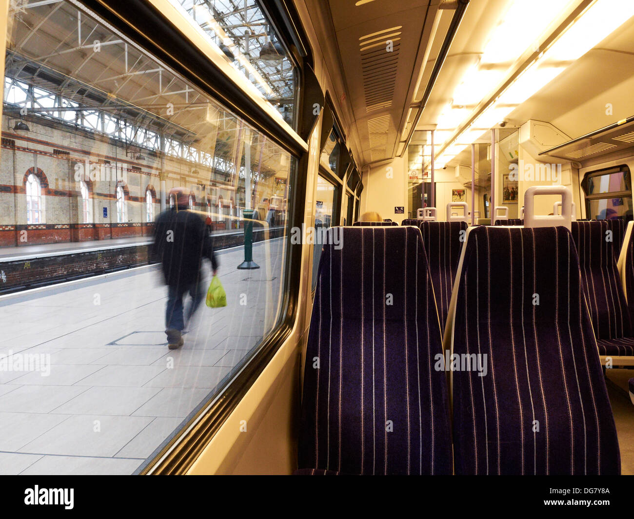 Commuter running for the train at Piccadilly Station Manchester UK