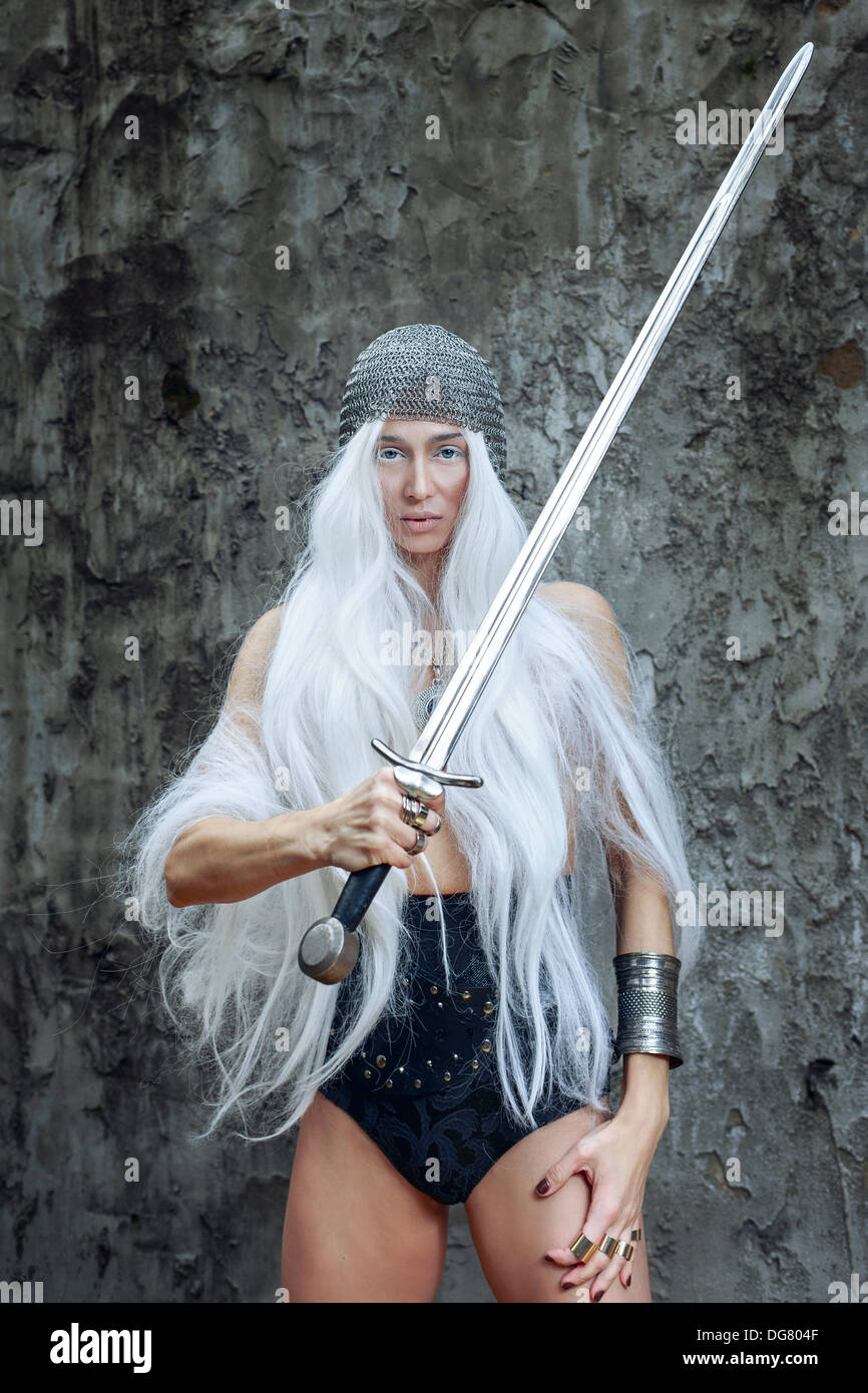 Girl with long white hair in chain mail and sword Stock Photo