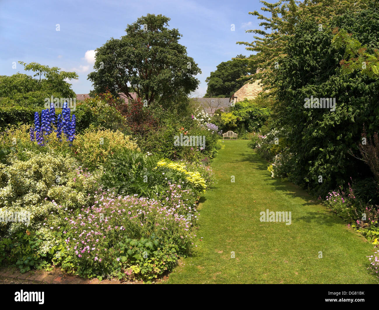 Green grass lawn and deep flower border, Barnsdale Gardens, Oakham, Rutland, England, UK. Stock Photo