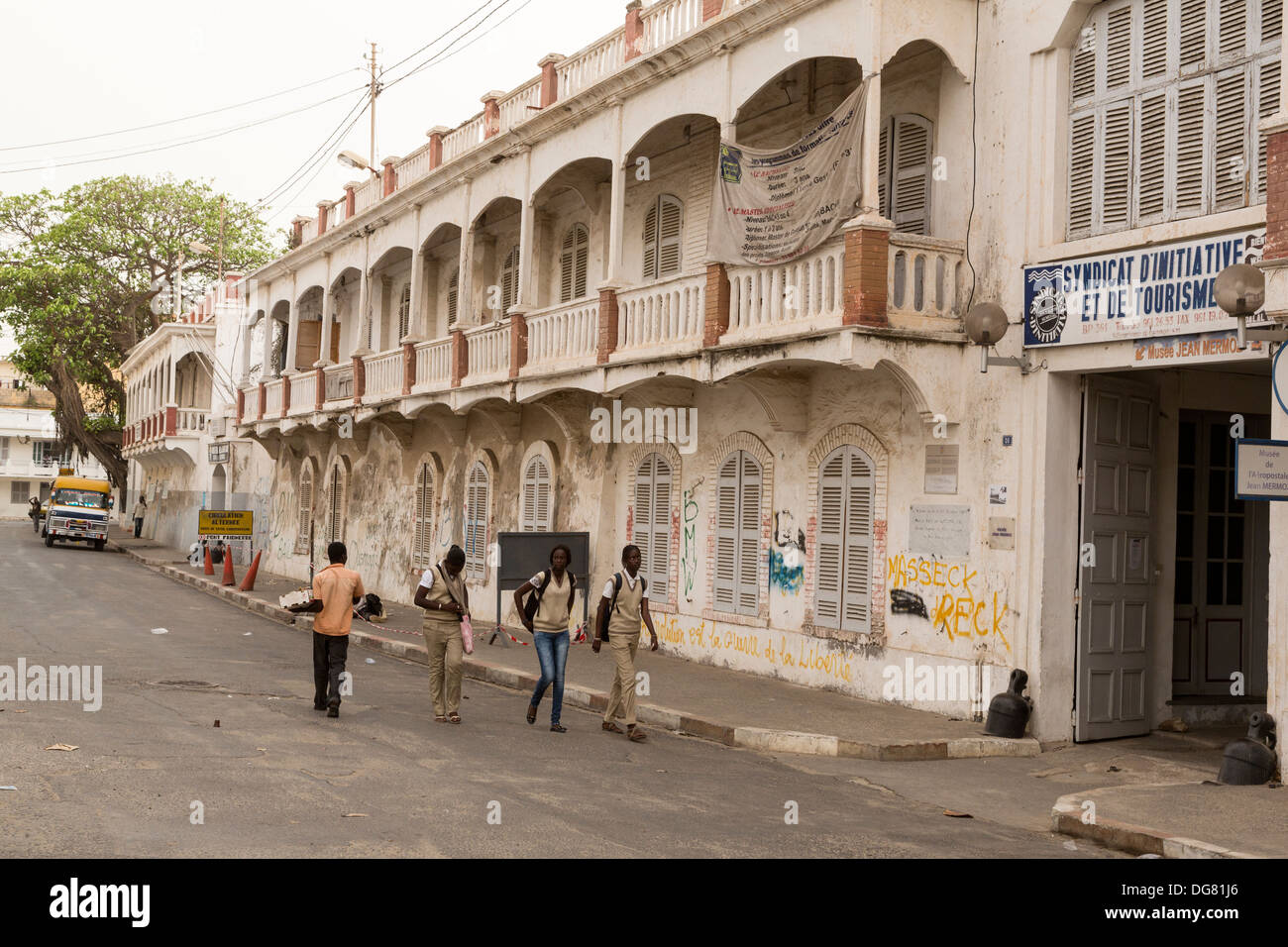 Senegal, Saint Louis. French Colonial-era Architecture. Young Female Students Walking. Stock Photo