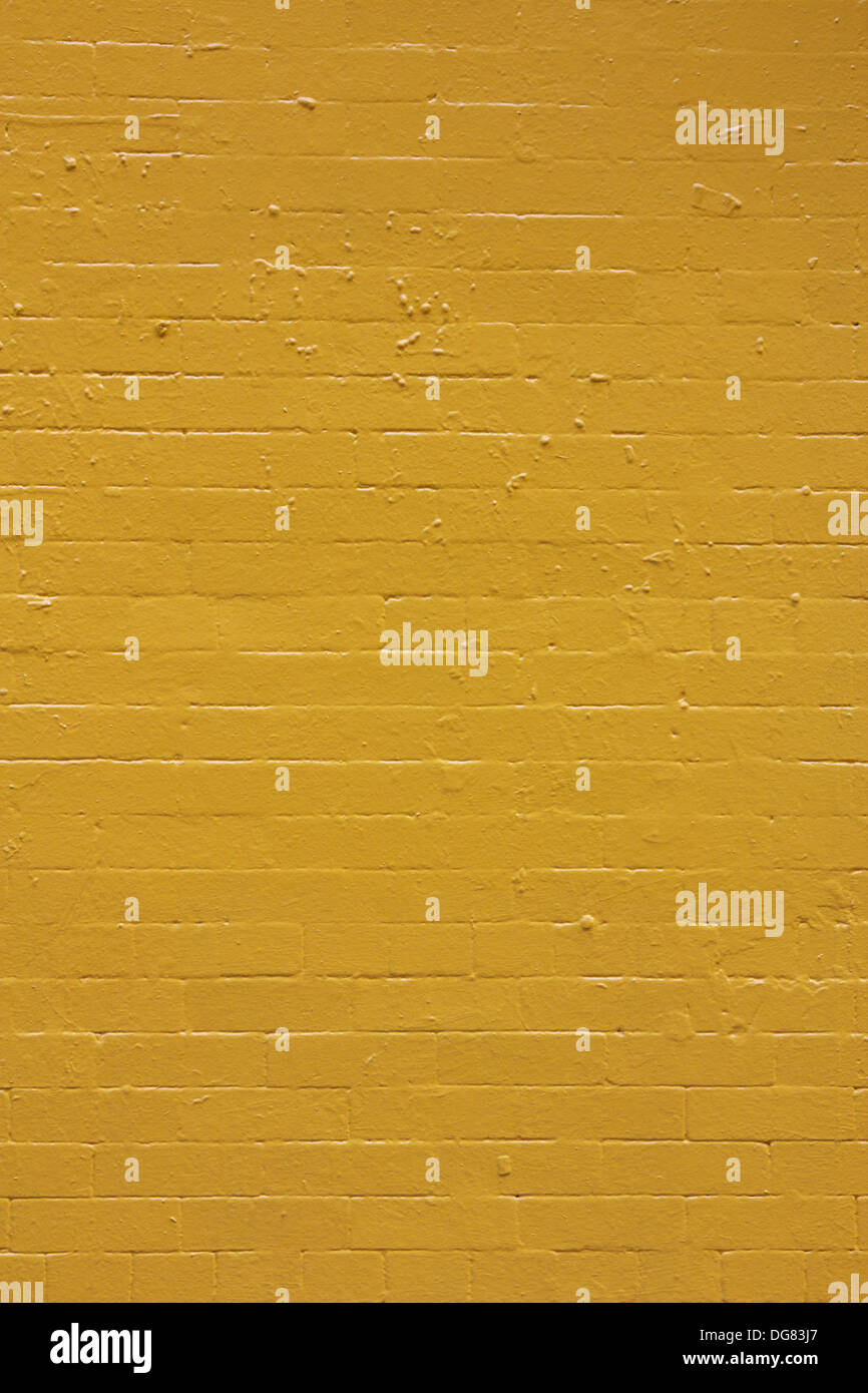 Yellow painted brick wall texture. Stock Photo