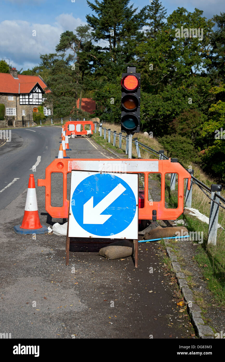 Temporary traffic light lights signal on at red at roadworks England UK United Kingdom GB Great