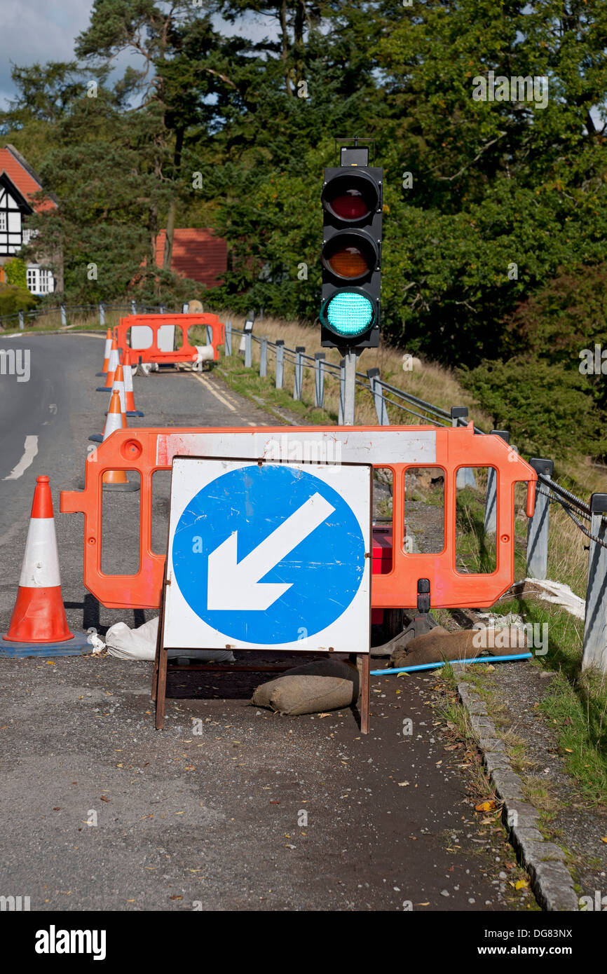 Temporary traffic light lights signal signals on green at roadworks road England UK United Kingdom GB Great Britain Stock Photo