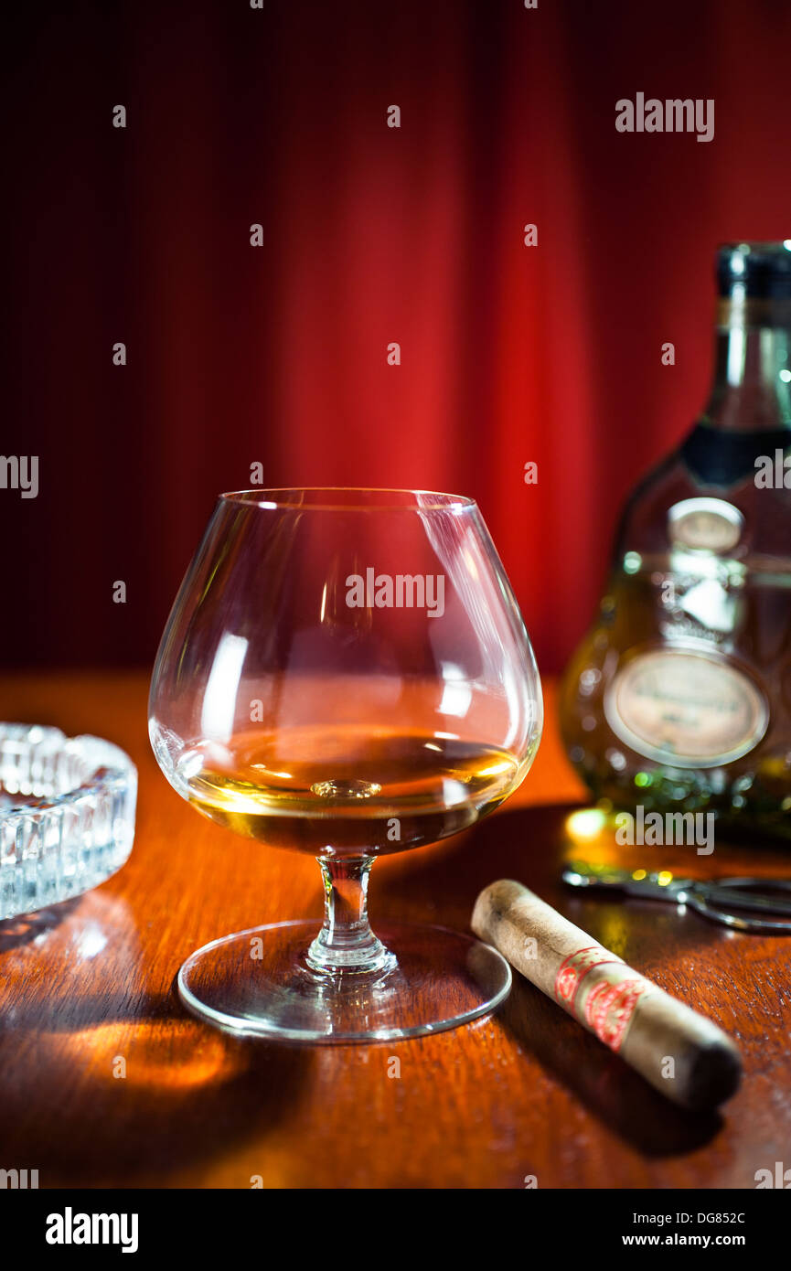 Brandy and cigars - A snifter glass of Hennessy XO Cognac with a large cigar Stock Photo