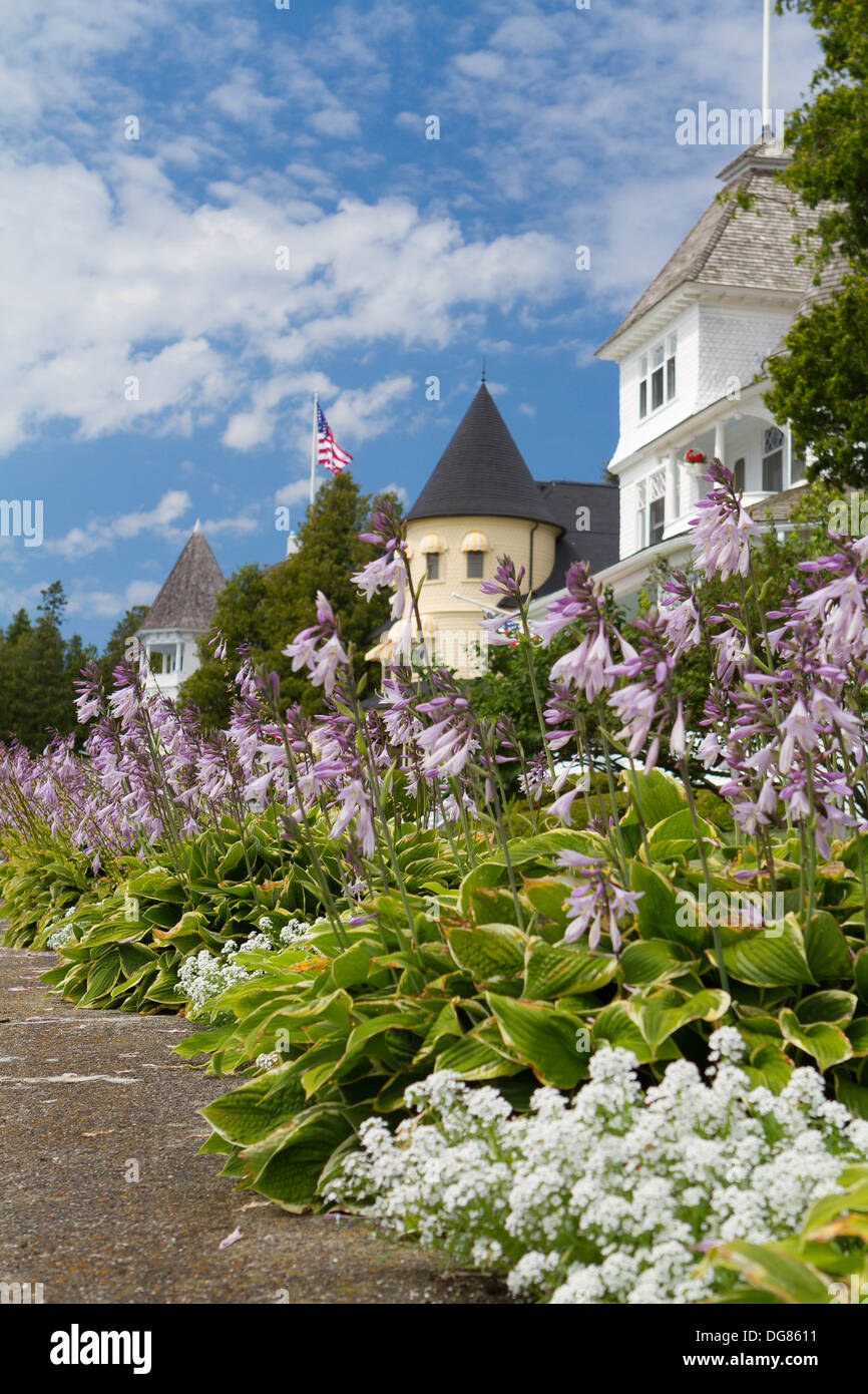 Beautiful Victorian homes on Mackinac Island with flower beds with