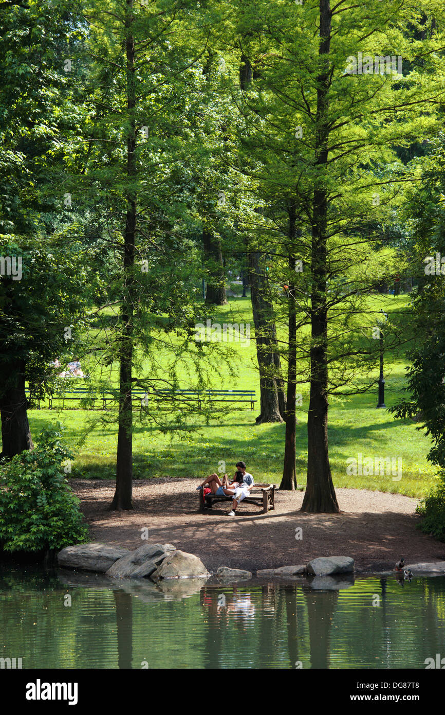 Couple sitting on a bench in Central Park, New York, USA Stock Photo