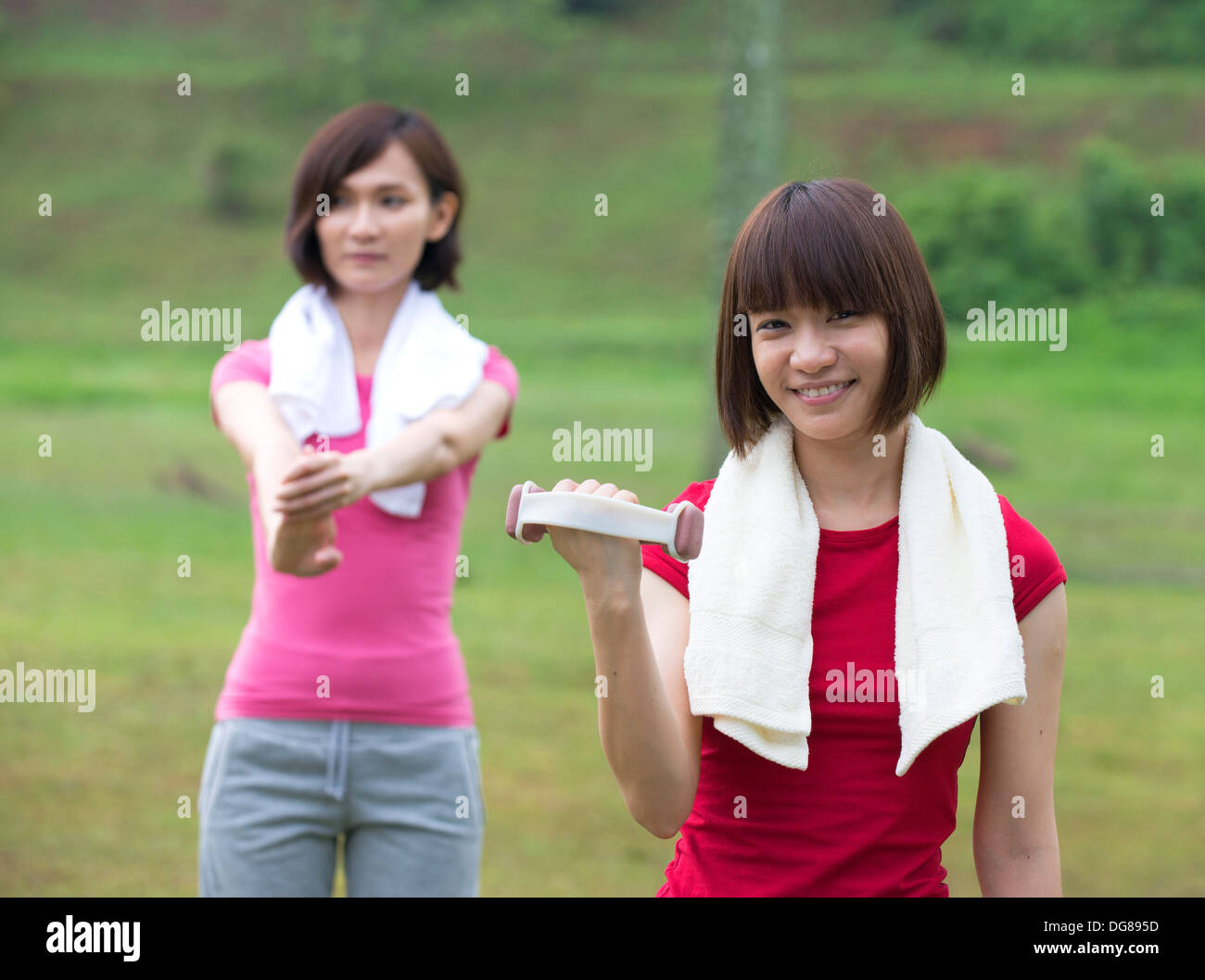 asian girls working out outdoor park Stock Photo